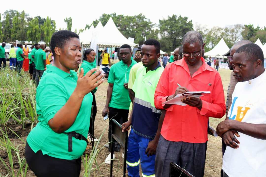 National Sugarcane Research Coordinator Minza Masunga ( Left) elaborating some issues to farmers during Farmers Day Event in Kilombero