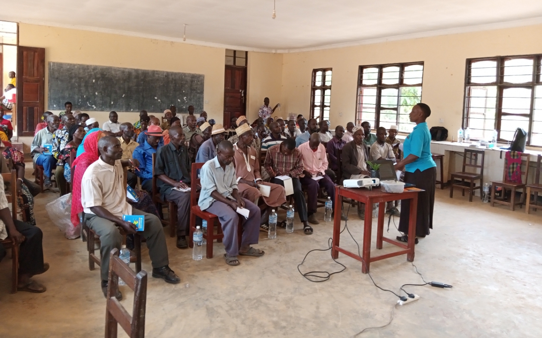 Researcher from TARI Kihinga Mrs Joyce Mushumbusi making a presentation to farmers from various villages of Bitale Ward about the Establishment and Management of Oil Palm farm at ongoing training in Kigoma District Council