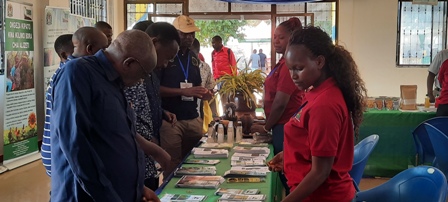 Sarah Mwakalinga Assistant Librarian, attending on disseminating materials to some of Agricultural stakeholders visited at TARI Pavilion during Farmer Agricultural Exhibition