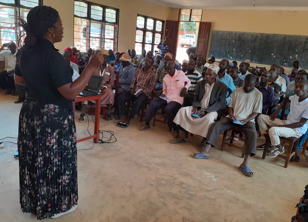 The Director of Technology Transfer and Partnership Dr. Juliana Mwakasendo talking to Farmers from Various Villages in  Bitale ward at the ongoing Training  in Kigoma Region about good agricultural practices of Oil Palm.