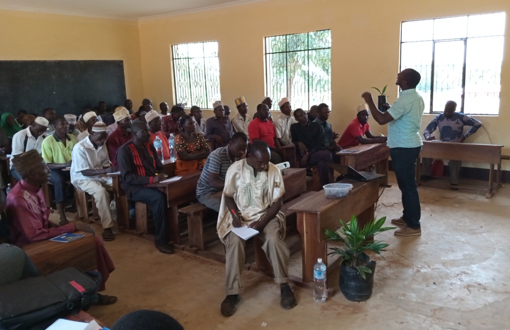 Researcher from TARI Kihinga Mr. Simo Mbayo presenting a topic on the establishment and management of Oil Palm nurseries to farmers from various villages in Simbo Ward at ongoing training about good agricultural practices of Oil Palm in Kigoma Region