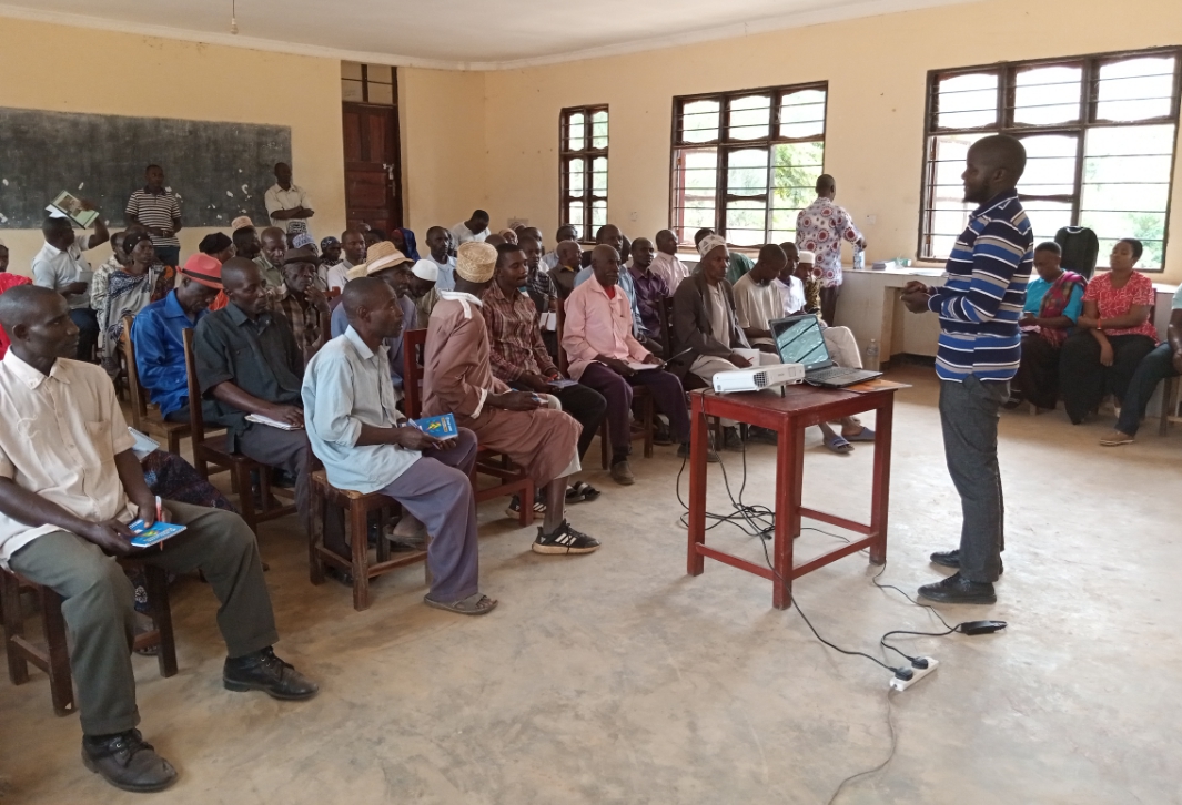 Researcher from TARI Kihinga Mr.Tawfiq Idrisa Mwijage presenting a topic on the establishment and maintenance of Oil Palm nurseries to farmers from various villages in Bitale Ward at ongoing  training about good agricultural practices on Oil Palm in Kigom