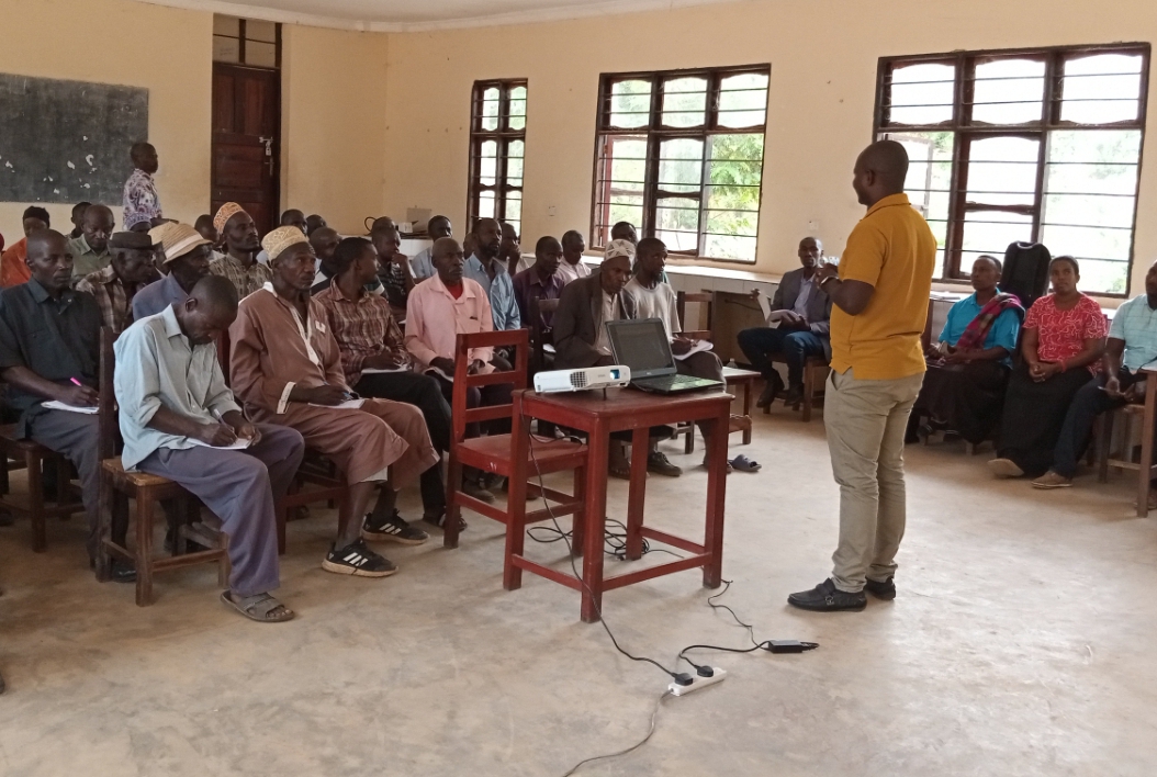 Coordinator of Research and Innovation  Mr. Masoud Salehe, giving an introductory presentation on the state of Oil Palm in Tanzania to farmers from various villages in Bitale Ward at ongoing training in Kigoma District Council.